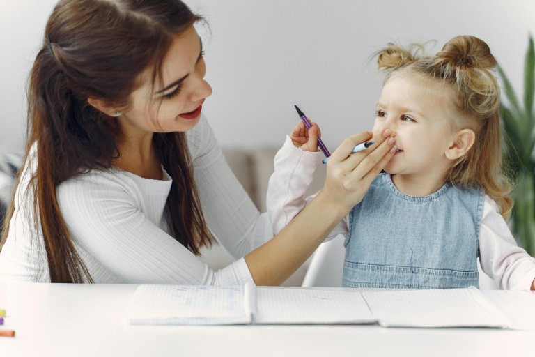 people pleasing childhood pattern showing caregiver correcting a child during a learning activity