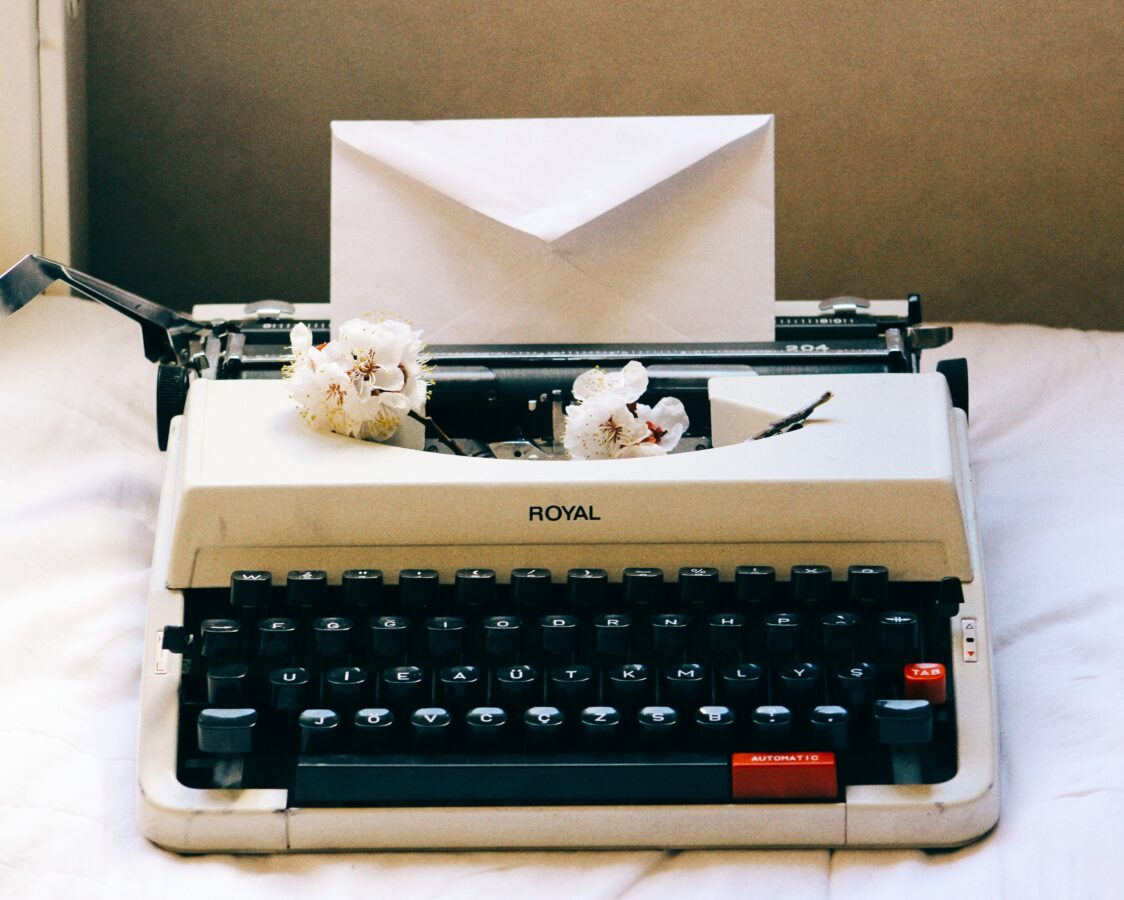 Vintage typewriter with envelope and flowers